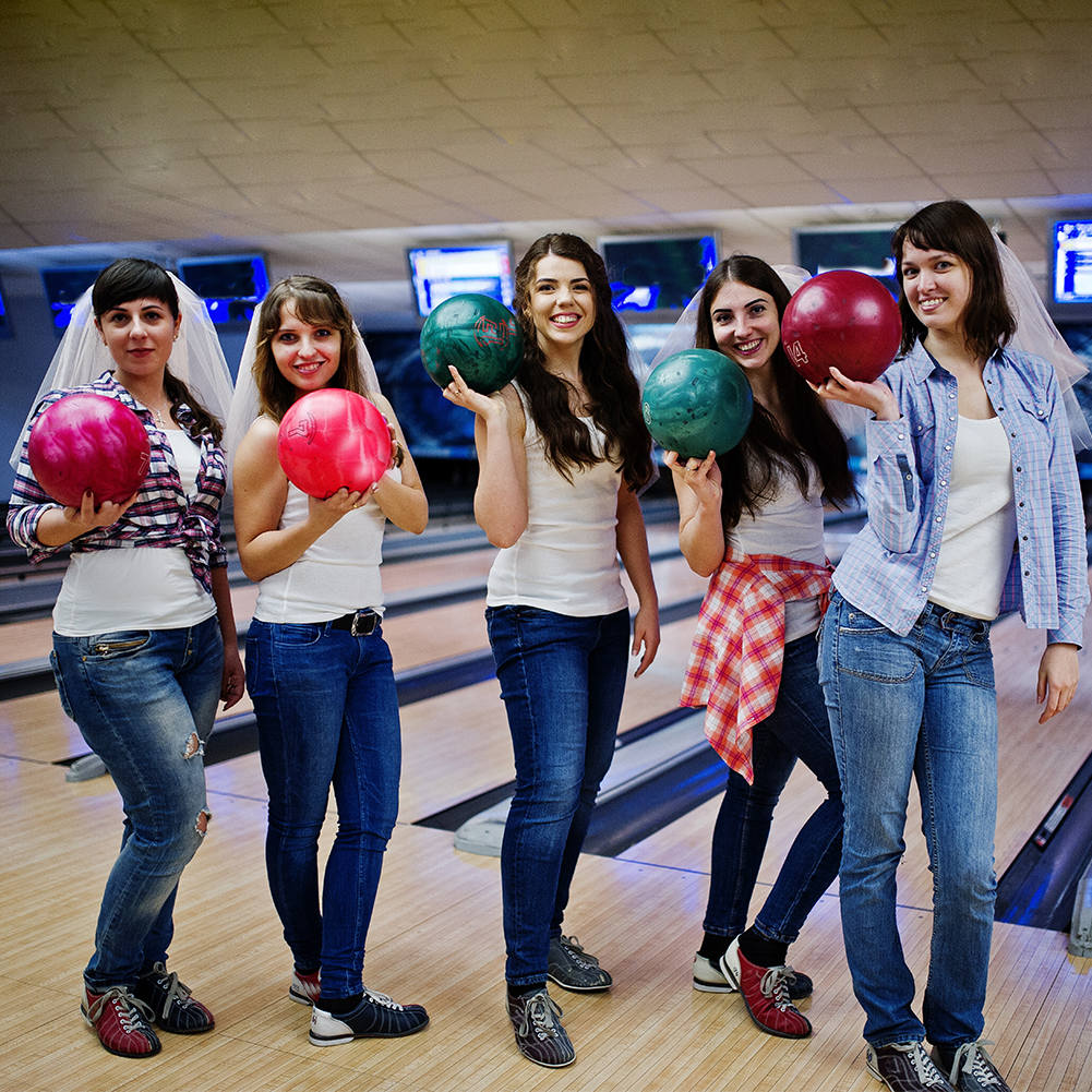 Group of six girls wit bowling balls at hen party on bowling club Group of six girls wit bowling balls at hen party on bowling club